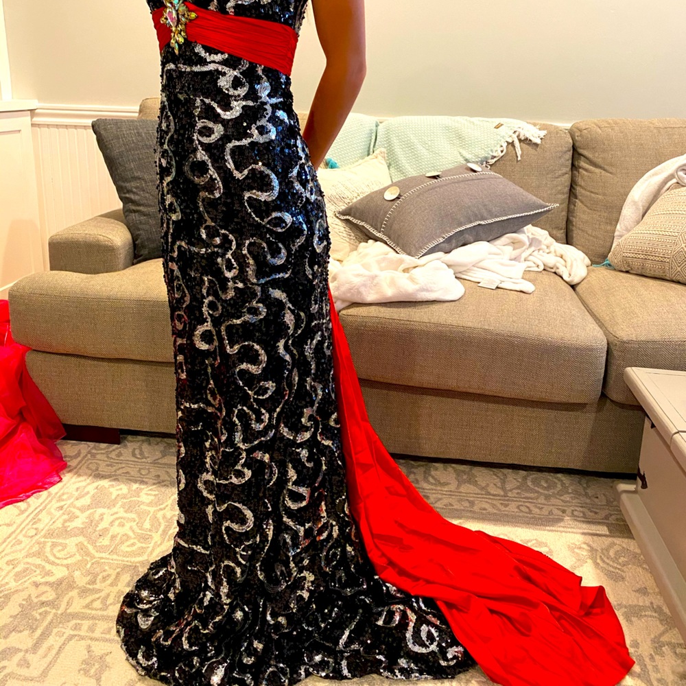 Black and silver sequin dress with red ribbon